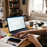 How to stop procrastinating by organizing tasks and focusing on work at a laptop